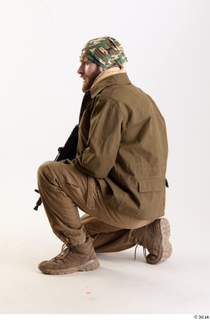 Andrew Elliott Insurgent Kneeling with Machine Gun holding machine gun…